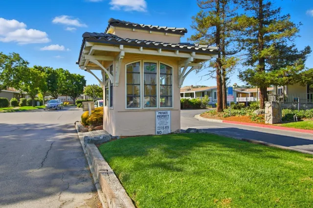 a front view of a house with a yard and outdoor seating