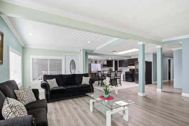 a living room with furniture and wooden floor