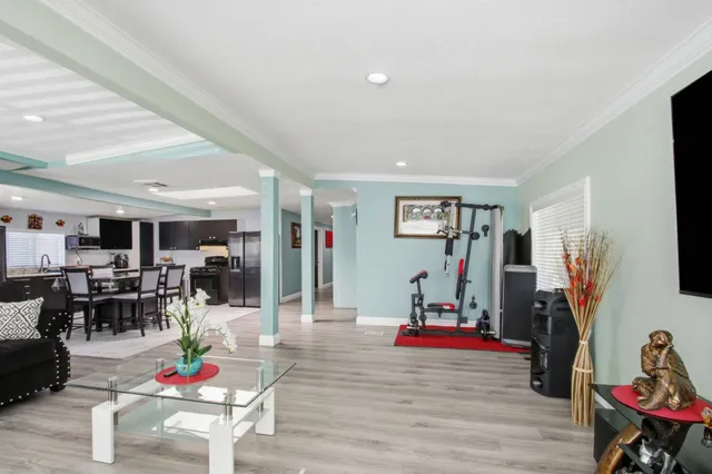 a living room with furniture gym equipment and a flat screen tv