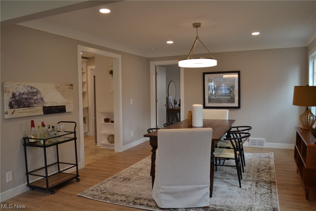 Dining space with light hardwood / wood-style floors