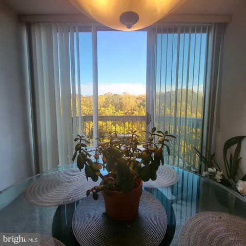 a living room with furniture and floor to ceiling windows