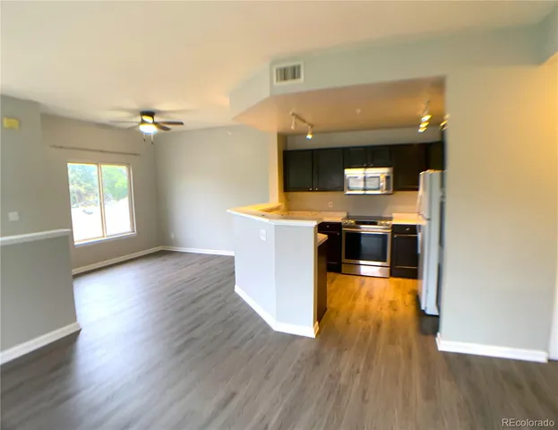 a view of a kitchen and a stove top oven