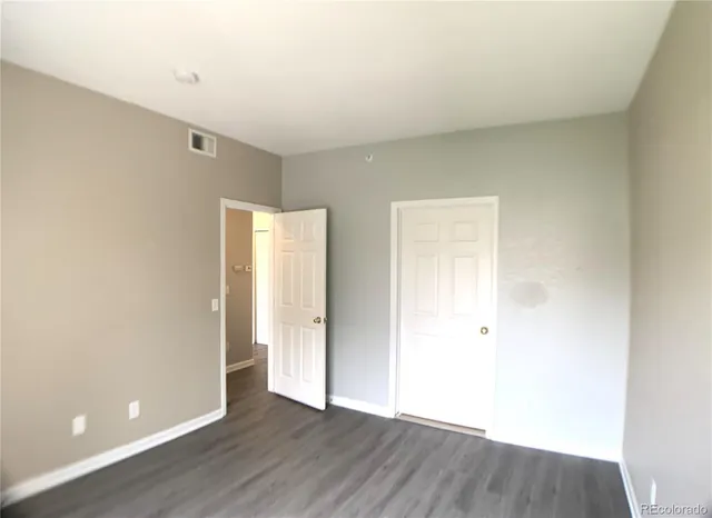 an empty room with wooden floor