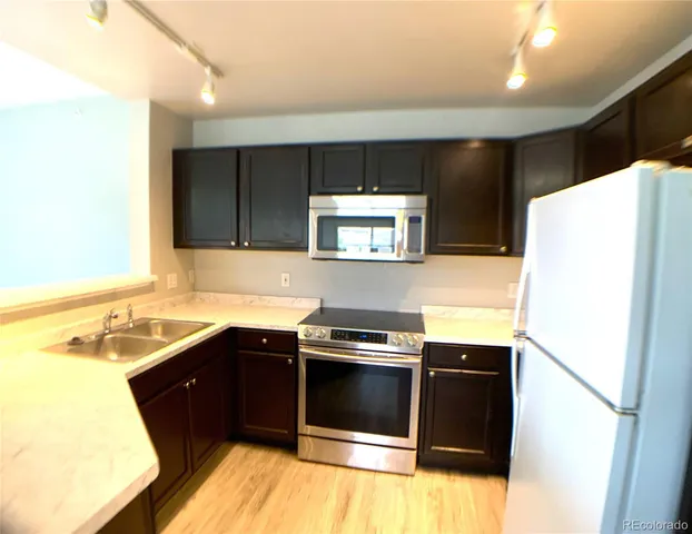 a kitchen with a sink and a refrigerator