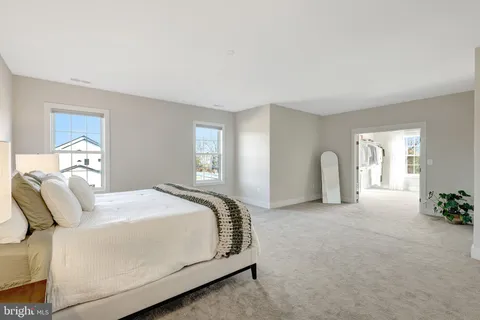 a spacious bedroom with a bed and a couch