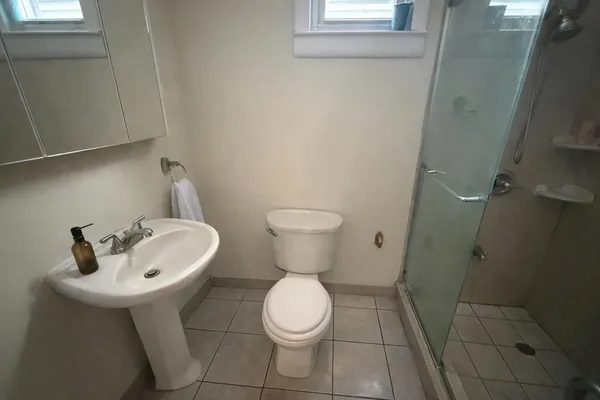 a bathroom with a toilet sink and mirror