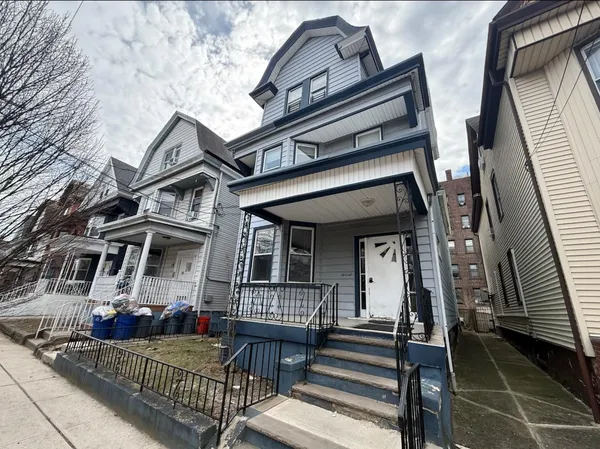 front view of a house with a small deck