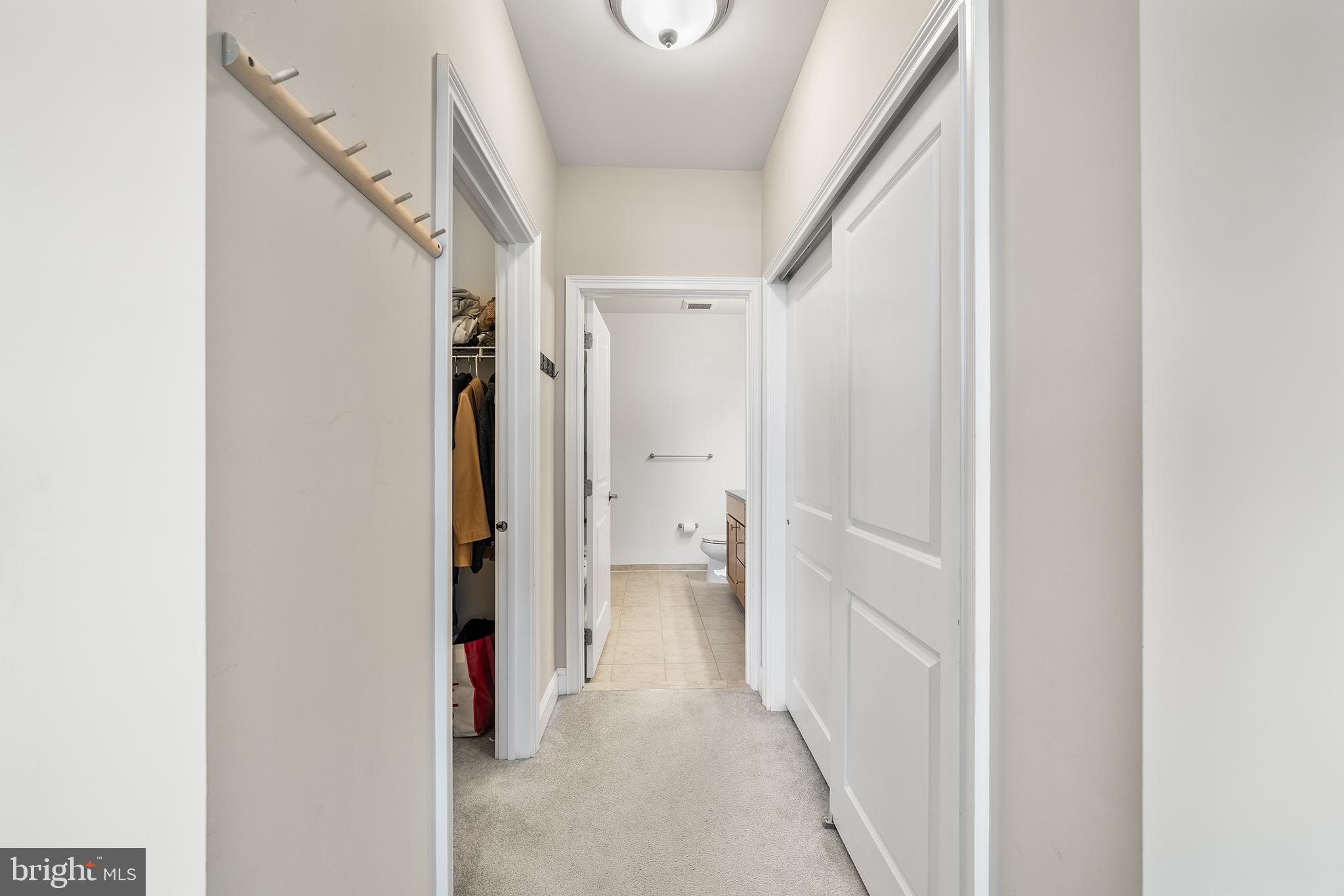 700 Commodore Court, Unit 2718 Philadelphia, PA 19146 - Photo 19 of 36 a view of a hallway with white walls and door