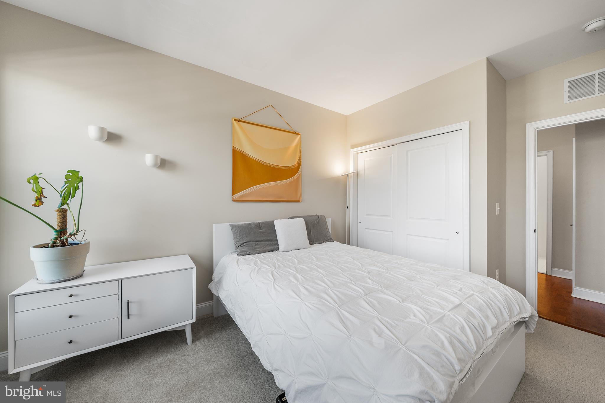 700 Commodore Court, Unit 2718 Philadelphia, PA 19146 - Photo 24 of 36 a bedroom with a bed and painting on the wall