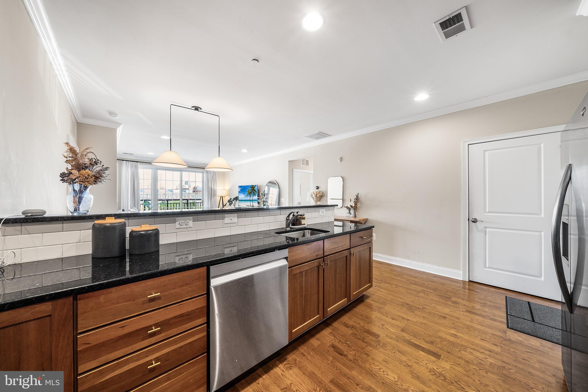 700 Commodore Court, Unit 2718 Philadelphia, PA 19146 - Photo 6 of 36 a kitchen with stainless steel appliances granite countertop a sink a stove and a wooden floors