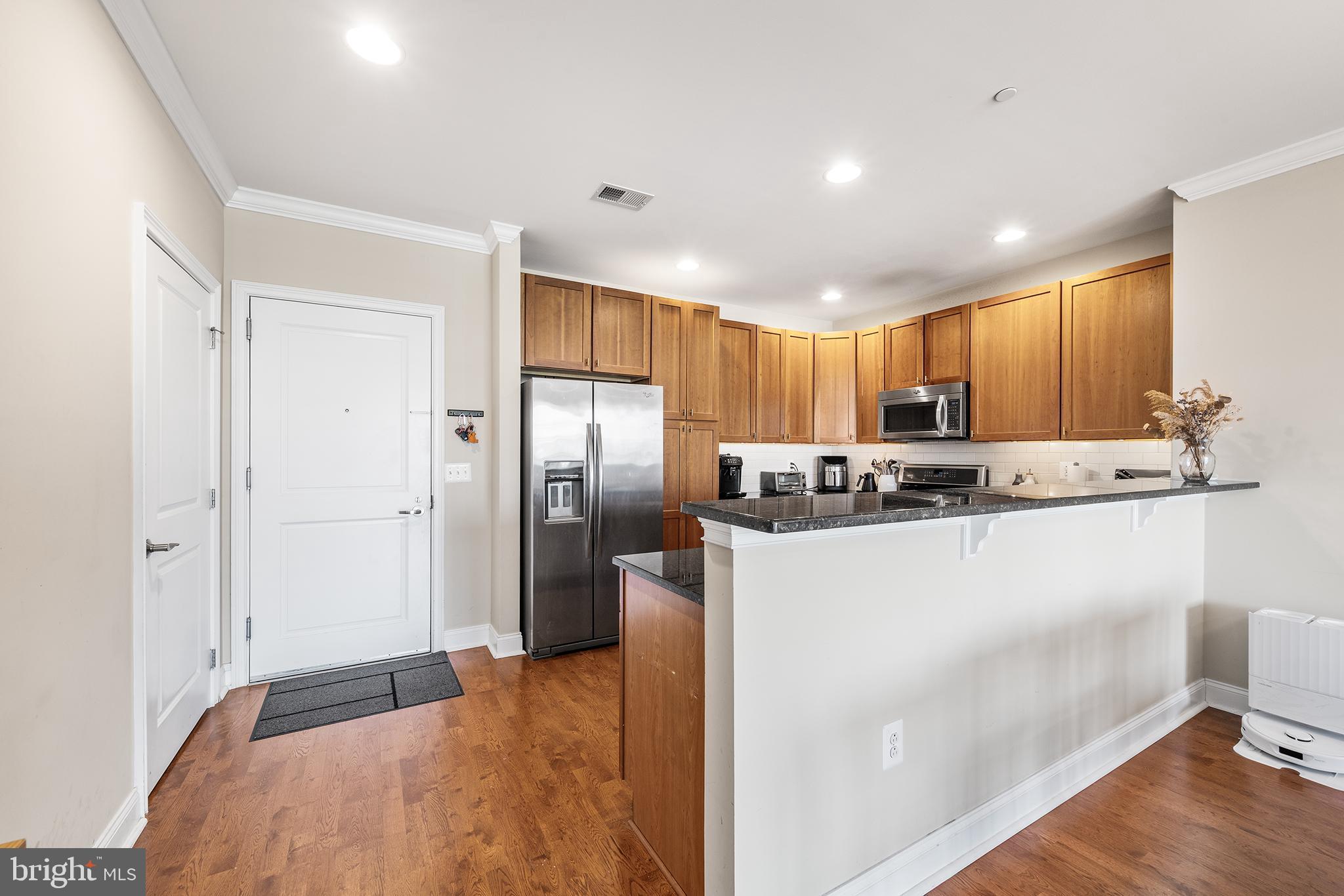 700 Commodore Court, Unit 2718 Philadelphia, PA 19146 - Photo 8 of 36 a kitchen with stainless steel appliances granite countertop a refrigerator and a stove top oven
