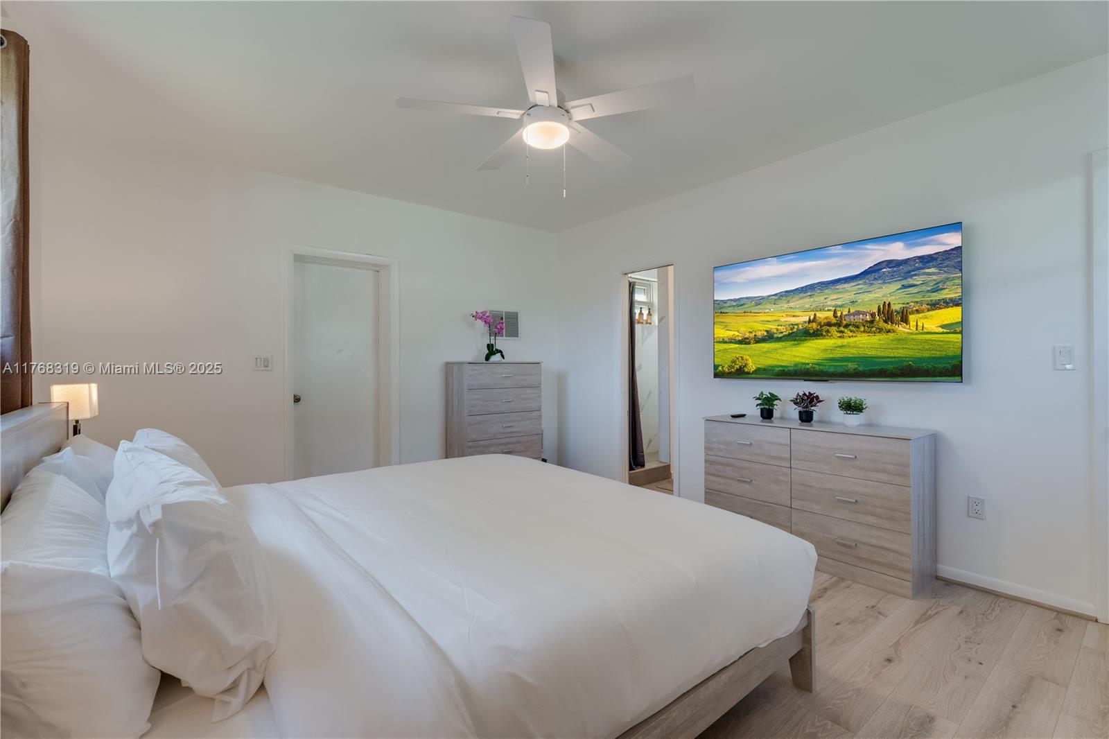 820 Southwest 26th Road Miami, FL 33129 - Photo 13 of 25 a bedroom with a bed and a flat screen tv