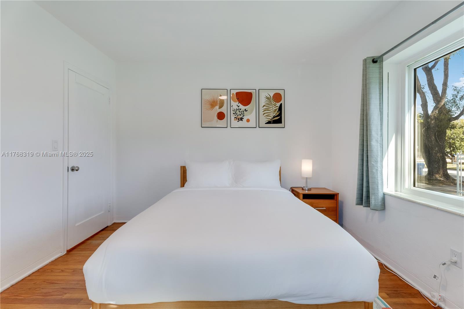 820 Southwest 26th Road Miami, FL 33129 - Photo 17 of 25 a bedroom with a bed and a window