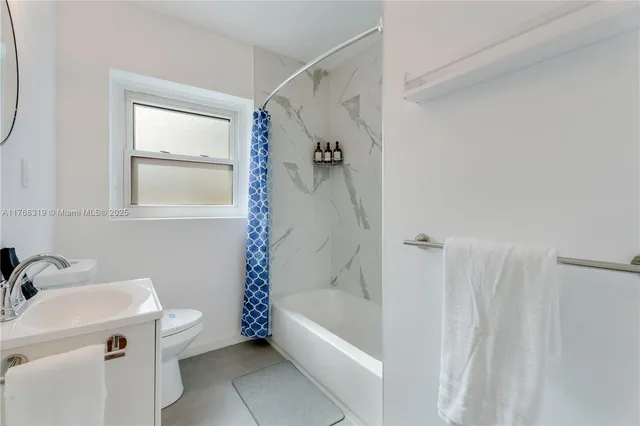 a bathroom with a tub a sink and a shower