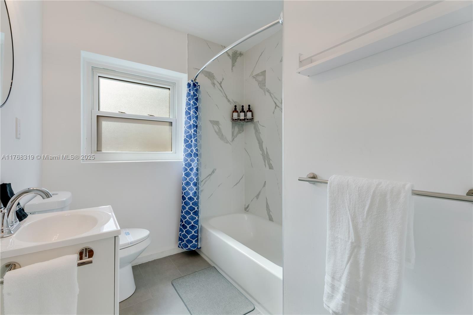 820 Southwest 26th Road Miami, FL 33129 - Photo 19 of 25 a bathroom with a tub a sink and a shower