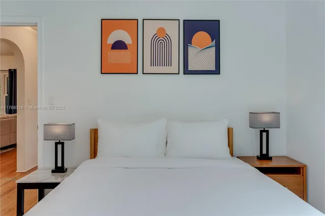 a bedroom with a bed and a lamp on table