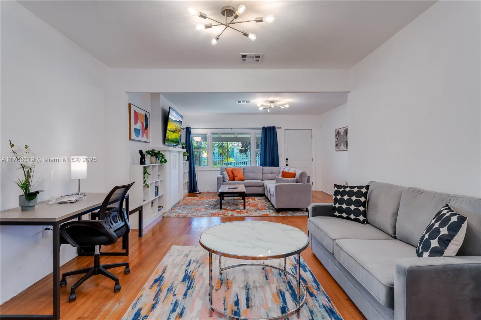 820 Southwest 26th Road Miami, FL 33129 - Photo 7 of 25 a living room with furniture and a wooden floor