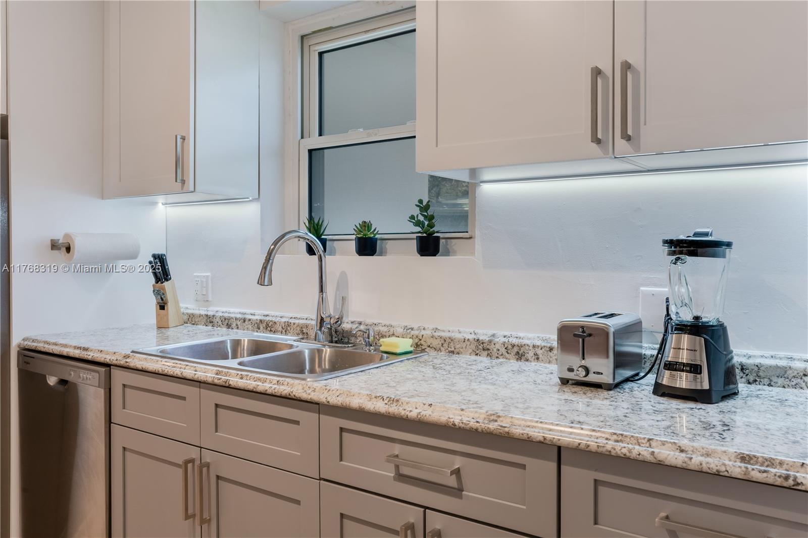 820 Southwest 26th Road Miami, FL 33129 - Photo 8 of 25 a kitchen with sink and cabinets