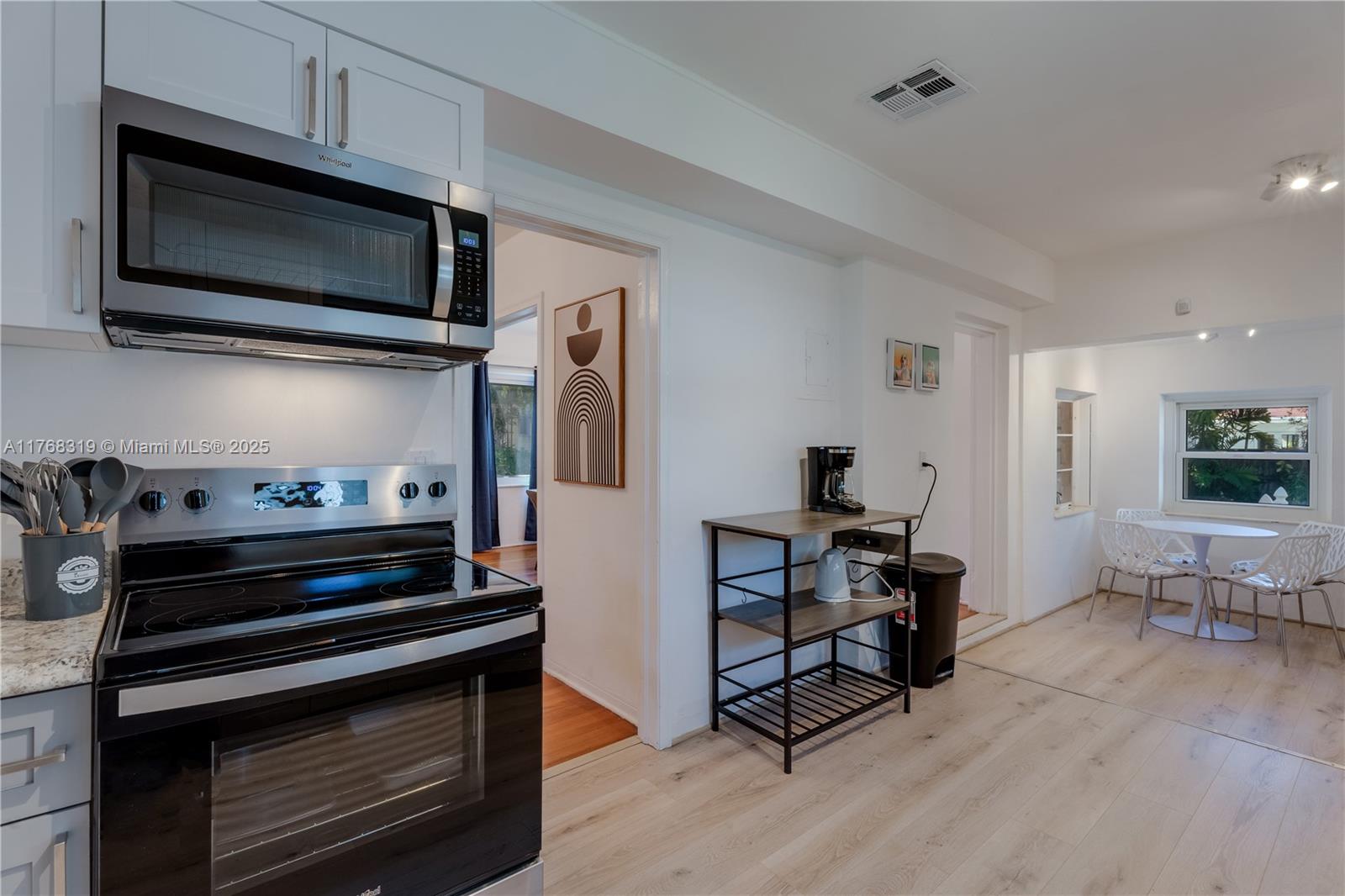 820 Southwest 26th Road Miami, FL 33129 - Photo 9 of 25 a kitchen with a stove and a microwave