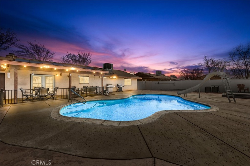 14638 Temecula Road Apple Valley, CA 92307 - Photo 1 of 1 a view of a swimming pool with an outdoor seating