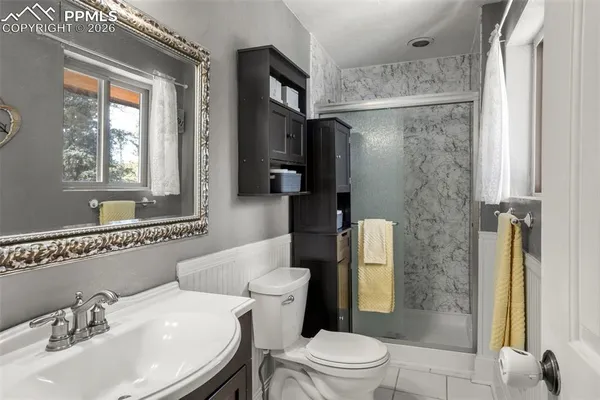 a bathroom with a sink toilet and shower