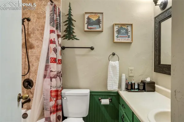 a bathroom with a sink vanity mirror and toilet