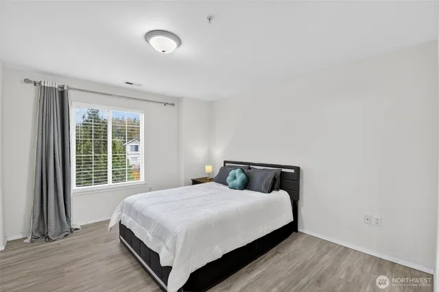 a bedroom with a bed and a window