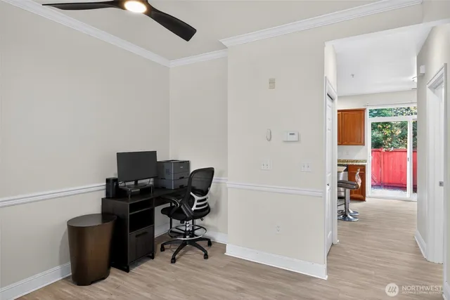a view of a workspace with furniture and a window