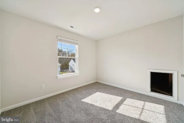 an empty room with windows and closet