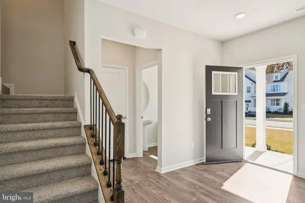 a view of entryway and hall with wooden floor