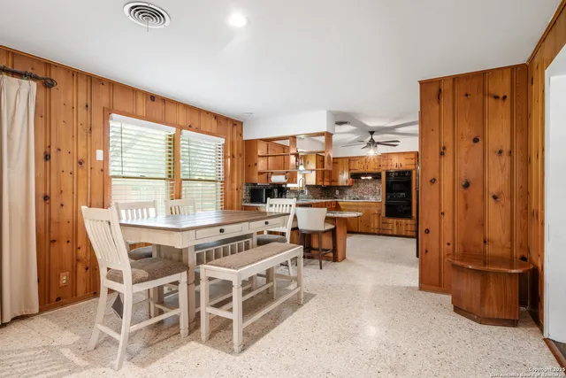 a dining room with furniture and a window