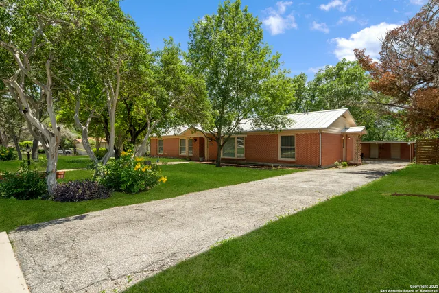a front view of a house with a yard and a garage