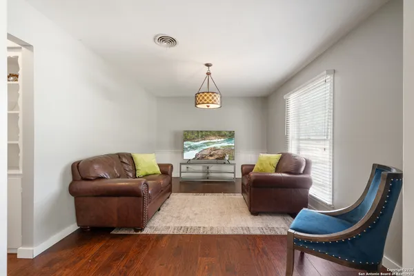 a living room with furniture rug and window
