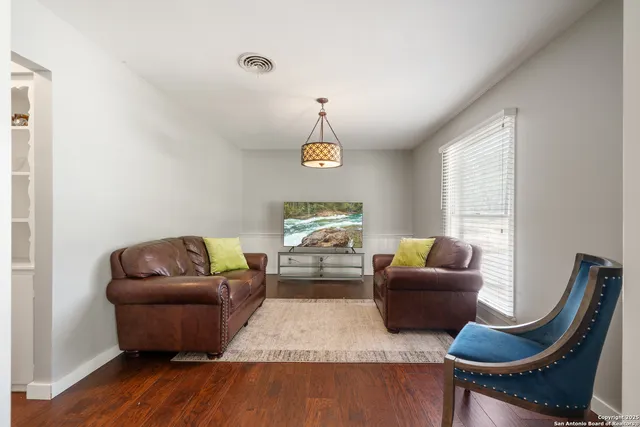 a living room with furniture rug and window