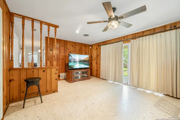 a view of a livingroom with furniture and a flat screen tv