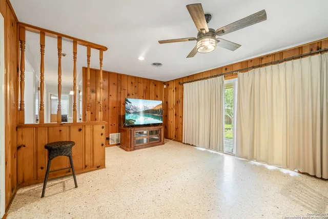 a view of a livingroom with furniture and a flat screen tv