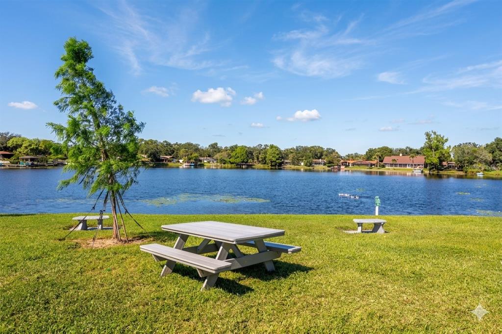 912 Lake Destiny Road, Unit F Altamonte Springs, FL 32714 - Photo 10 of 12 a swimming pool with outdoor seating and yard