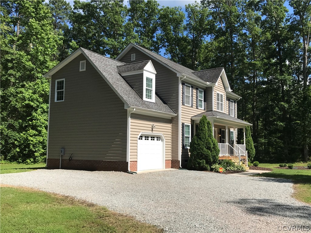 11452 Georgetown Road Mechanicsville, VA 23116 - Photo 2 of 27 a front view of a house with a yard and garage