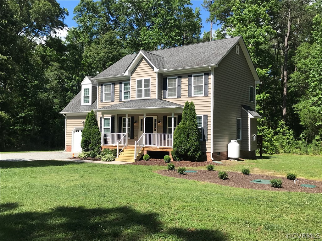 11452 Georgetown Road Mechanicsville, VA 23116 - Photo 3 of 27 a front view of a house with a yard table and chairs