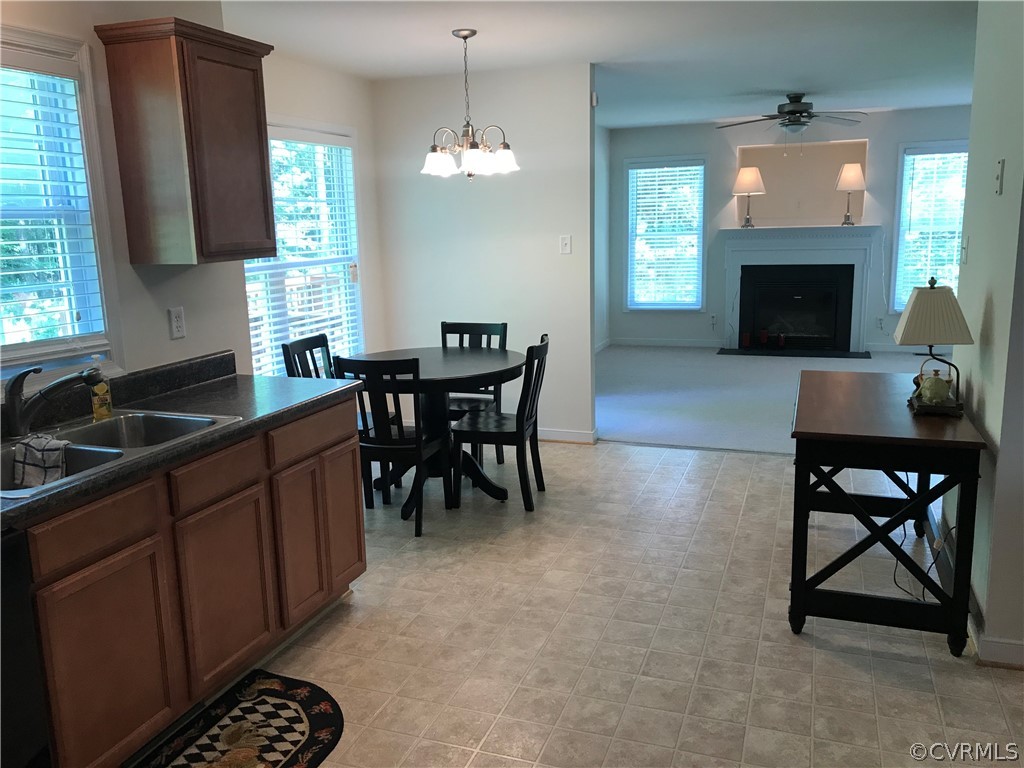 11452 Georgetown Road Mechanicsville, VA 23116 - Photo 9 of 27 a kitchen with a table chairs sink and cabinets