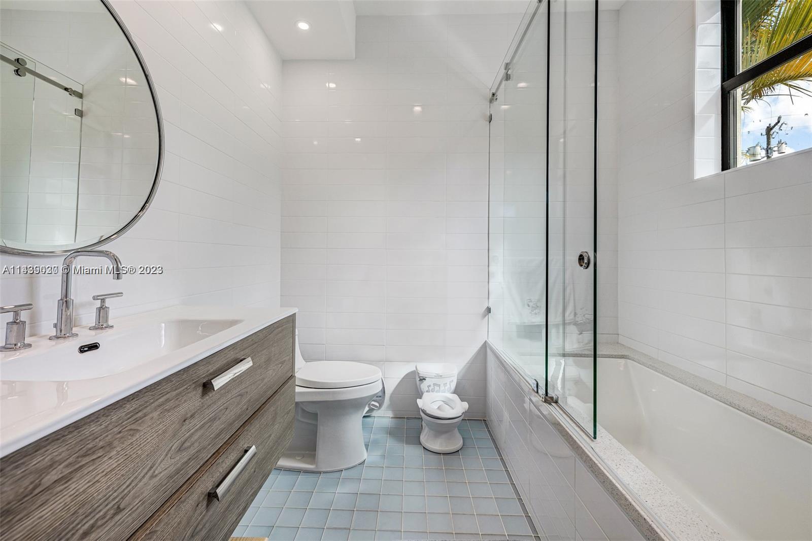 23 Samana Drive Miami, FL 33133 - Photo 14 of 19 a bathroom with a toilet sink and mirror