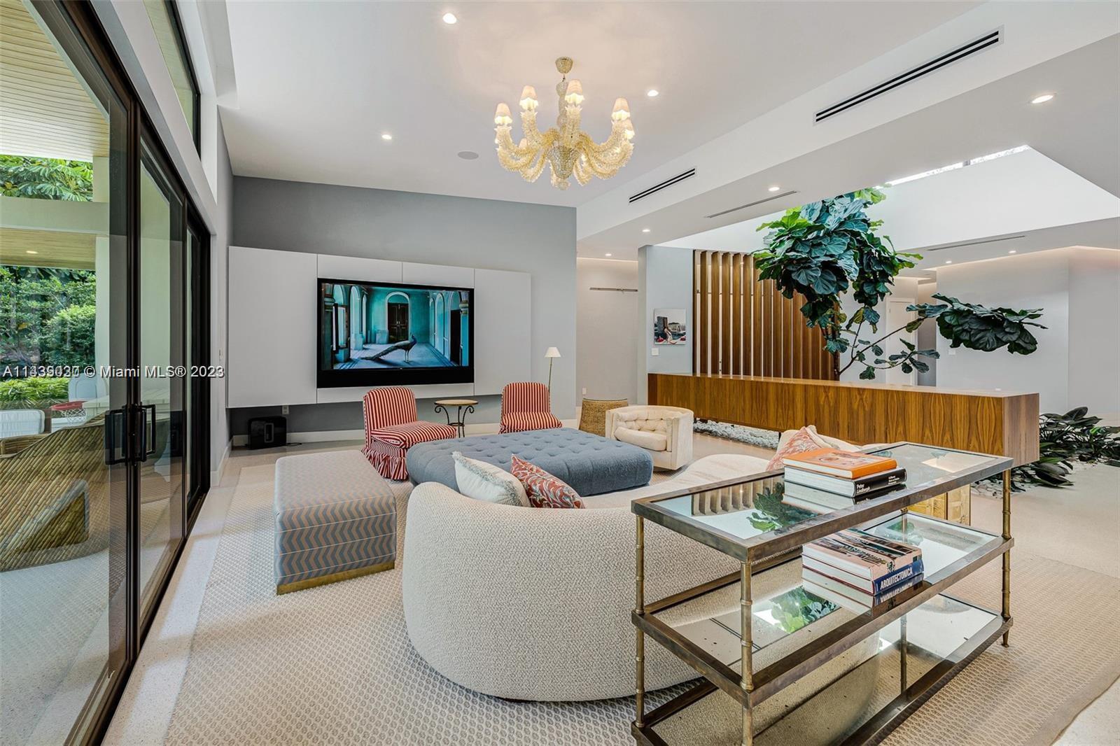 23 Samana Drive Miami, FL 33133 - Photo 6 of 19 a living room with furniture and a chandelier