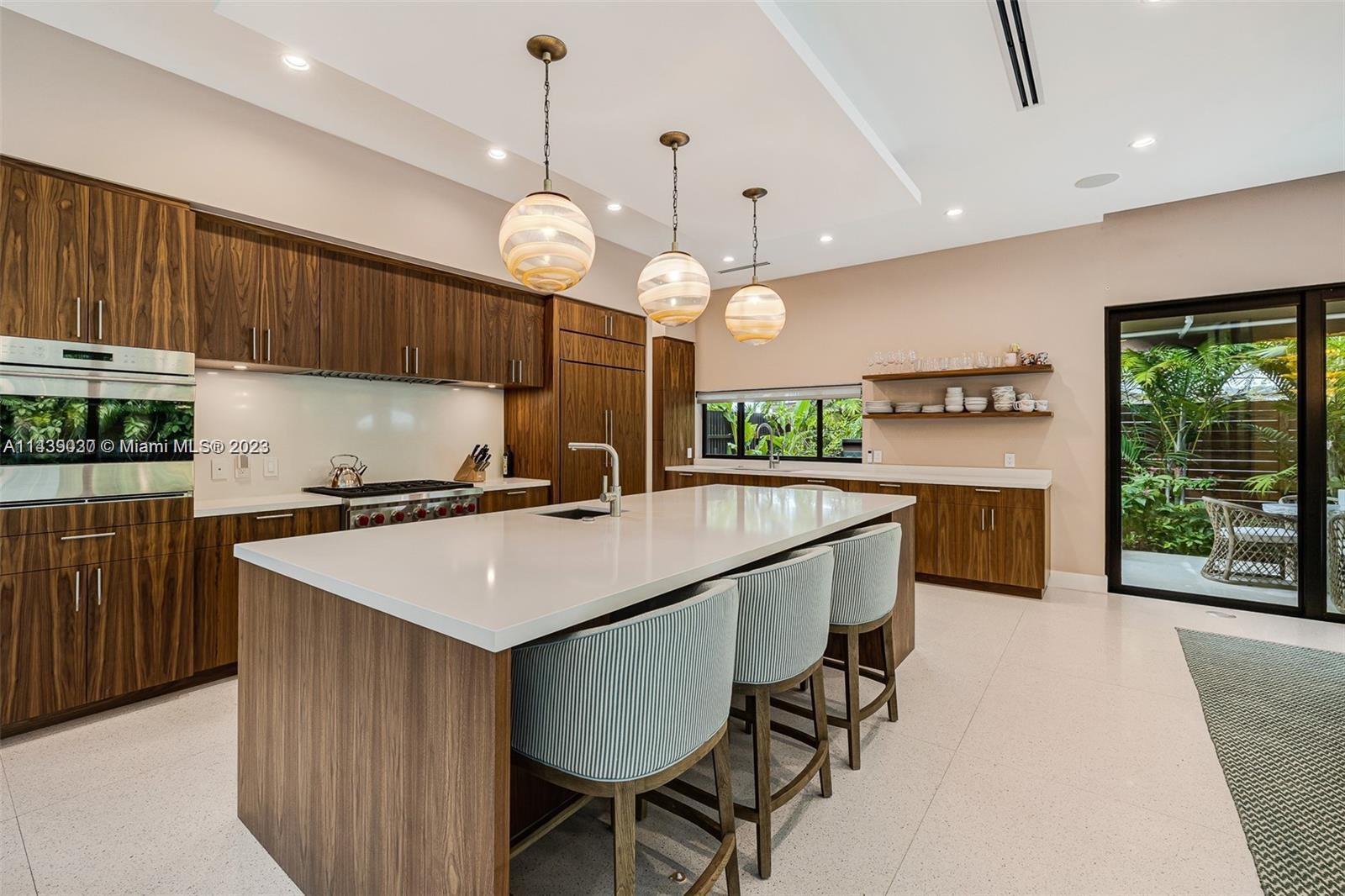 23 Samana Drive Miami, FL 33133 - Photo 7 of 19 a kitchen with a counter space cabinets and a chandelier