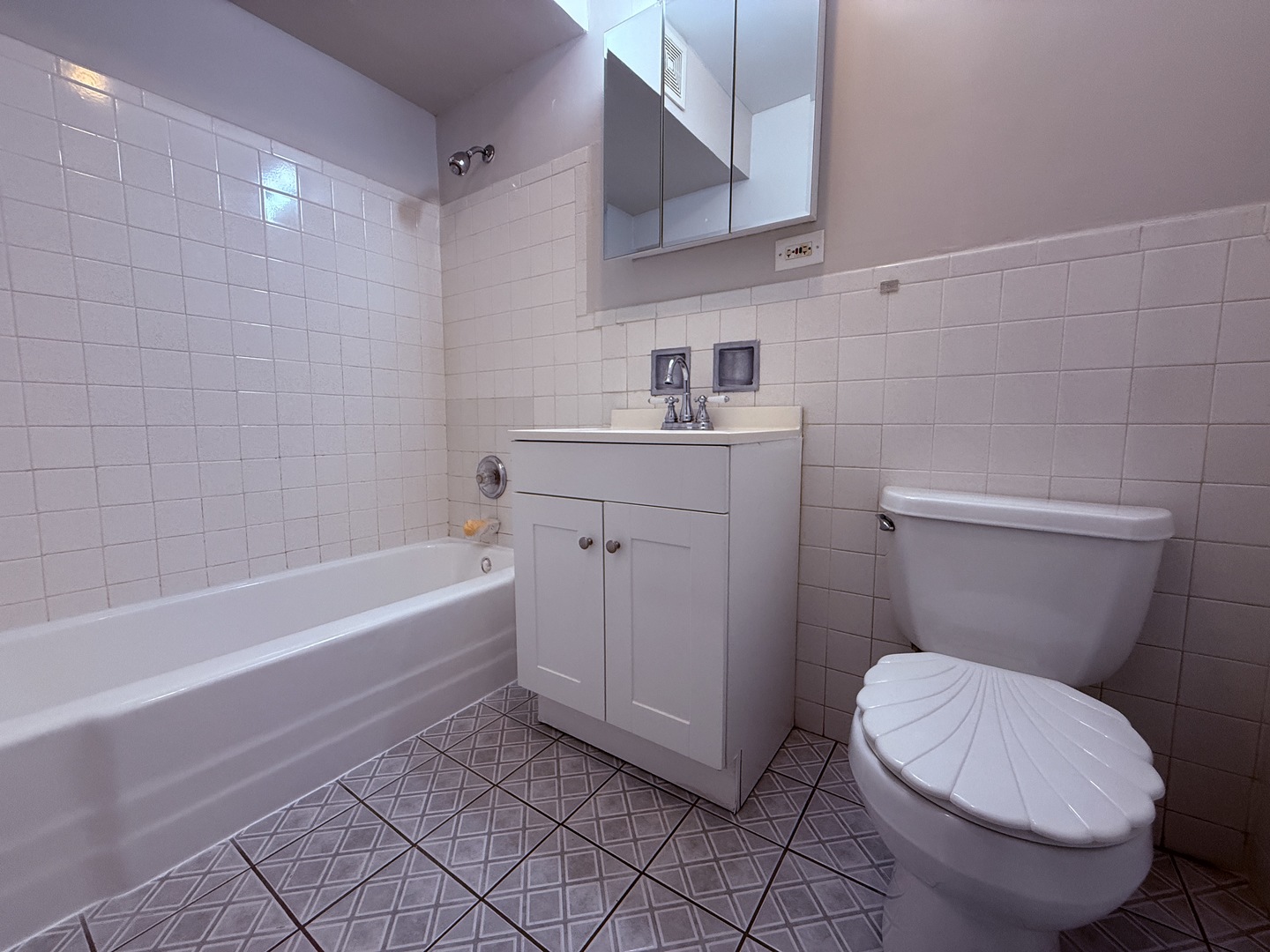 1119 East Algonquin Road, Unit 2 Arlington Heights, IL 60005 - Photo 11 of 13 a bathroom with a sink a toilet and bathtub
