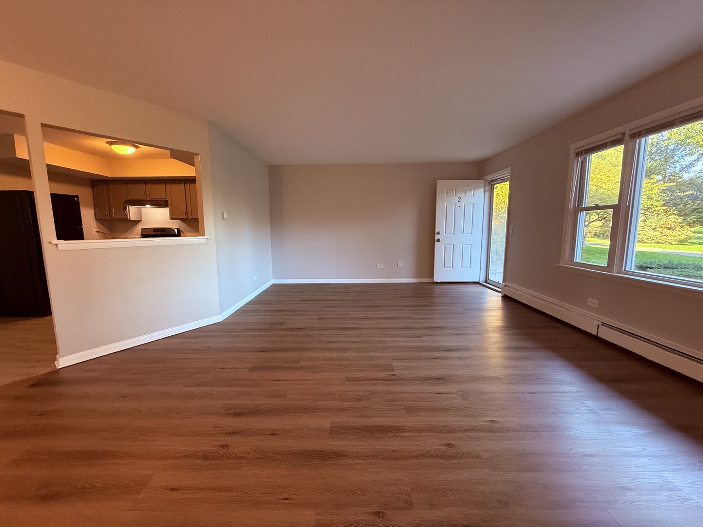 1119 East Algonquin Road, Unit 2 Arlington Heights, IL 60005 - Photo 6 of 13 a view of an empty room with wooden floor and a window