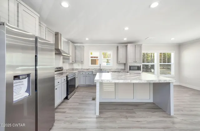 a kitchen with a sink stainless steel appliances and cabinets