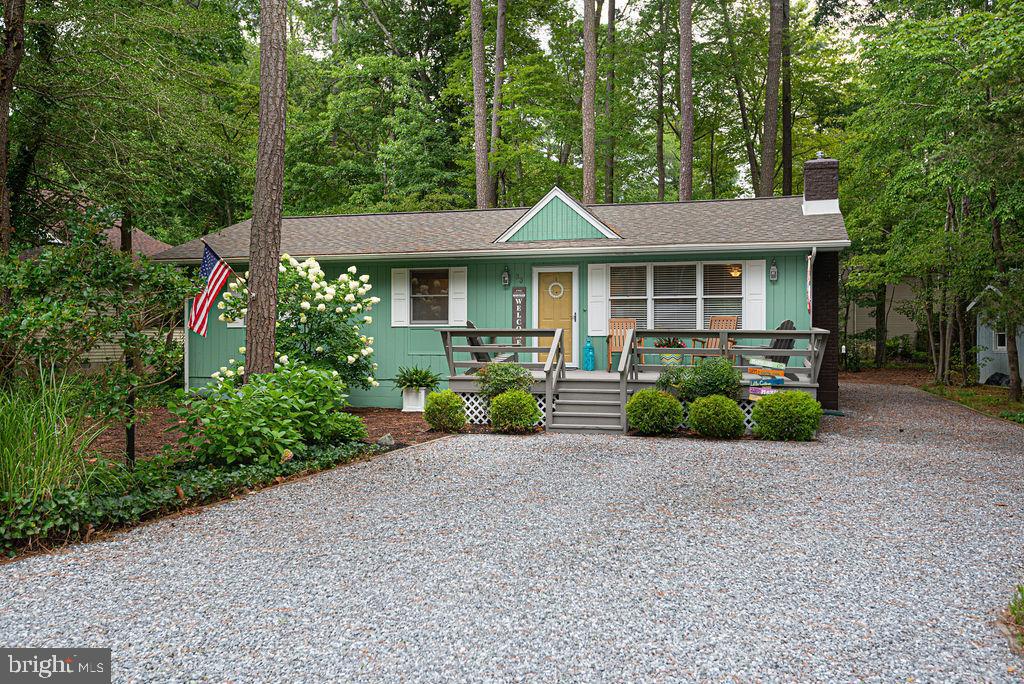33 Falcon Bridge Road Ocean Pines, MD 21811 - Photo 2 of 71 a front view of a house with a garden and porch