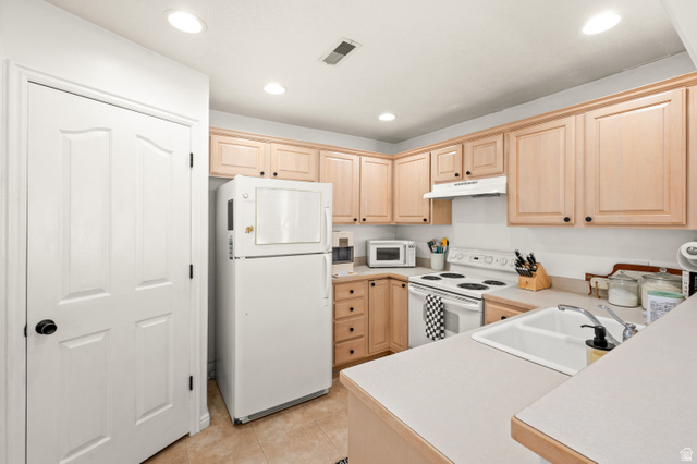 174 Rockey Park Lane, Unit 34 Draper, UT 84020 - Photo 5 of 20 Kitchen with white appliances, light wood finish cabinets, light countertops, light tile patterned floors, and recessed lighting