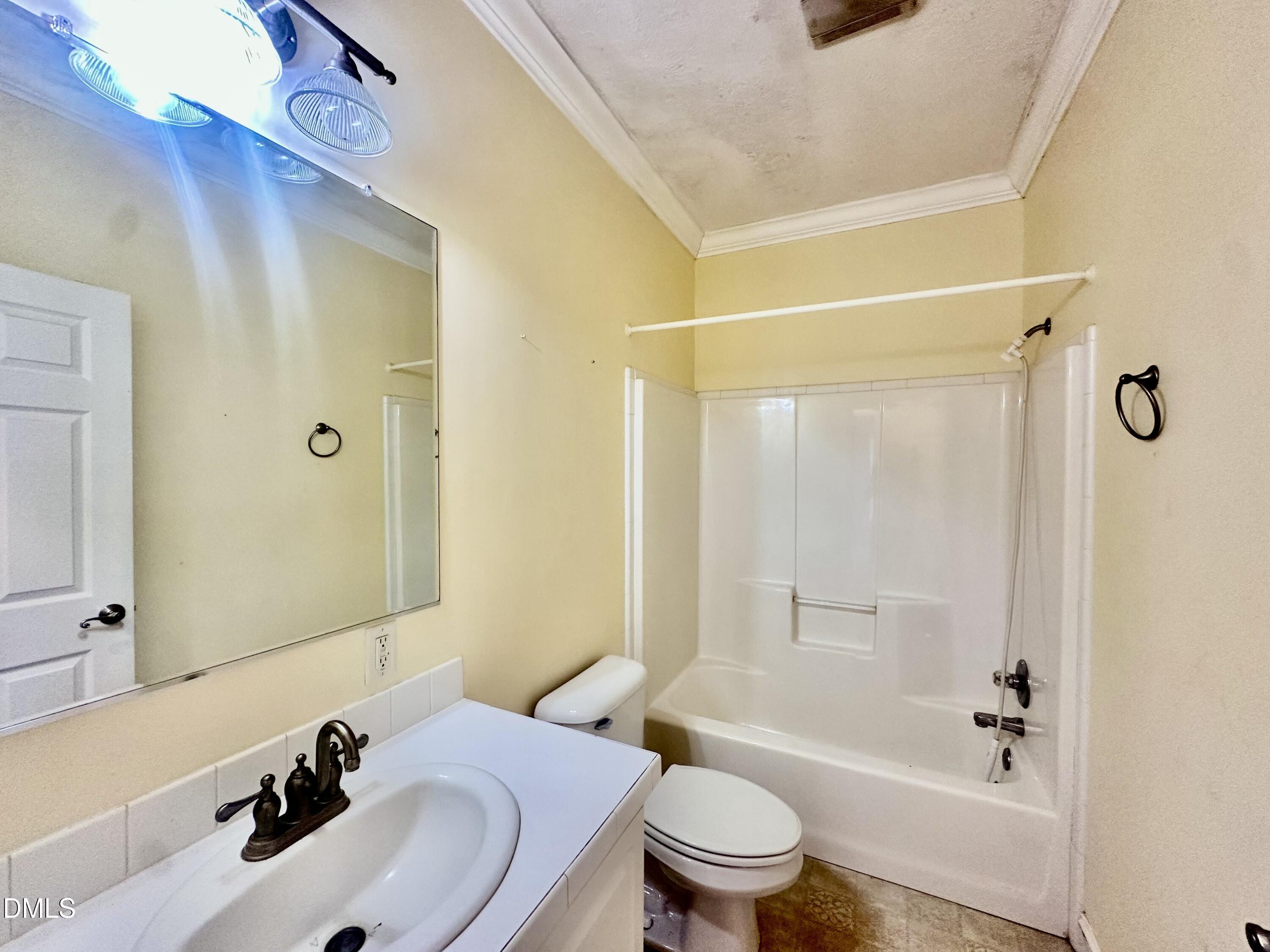 155 Collin Drive Roxboro, NC 27574 - Photo 12 of 20 a bathroom with a sink a toilet and shower