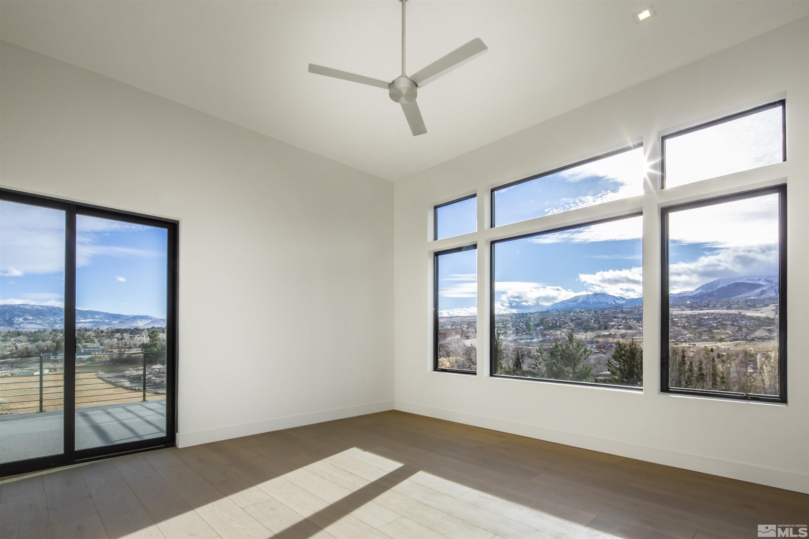 2331 Diamond J Place Reno, NV 89511 - Photo 6 of 25 a view of an empty room with wooden floor and a window